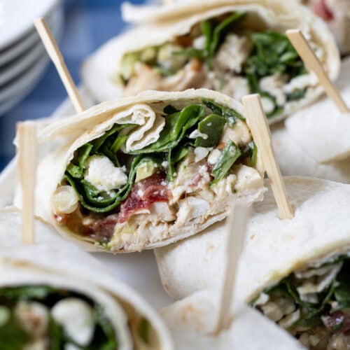 Cobb Salad Wraps stacked together on a plater.
