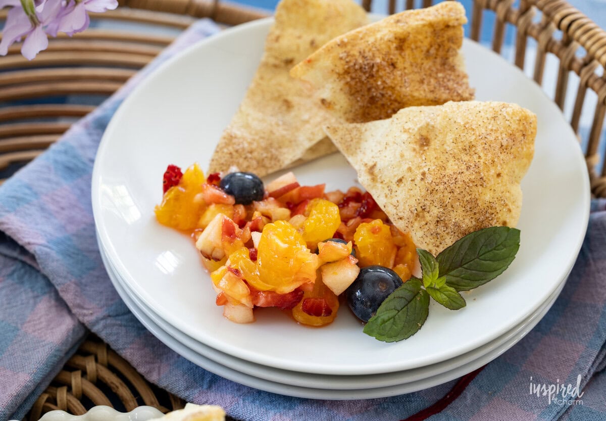 fruit salsa served on a plate with tortilla chips.