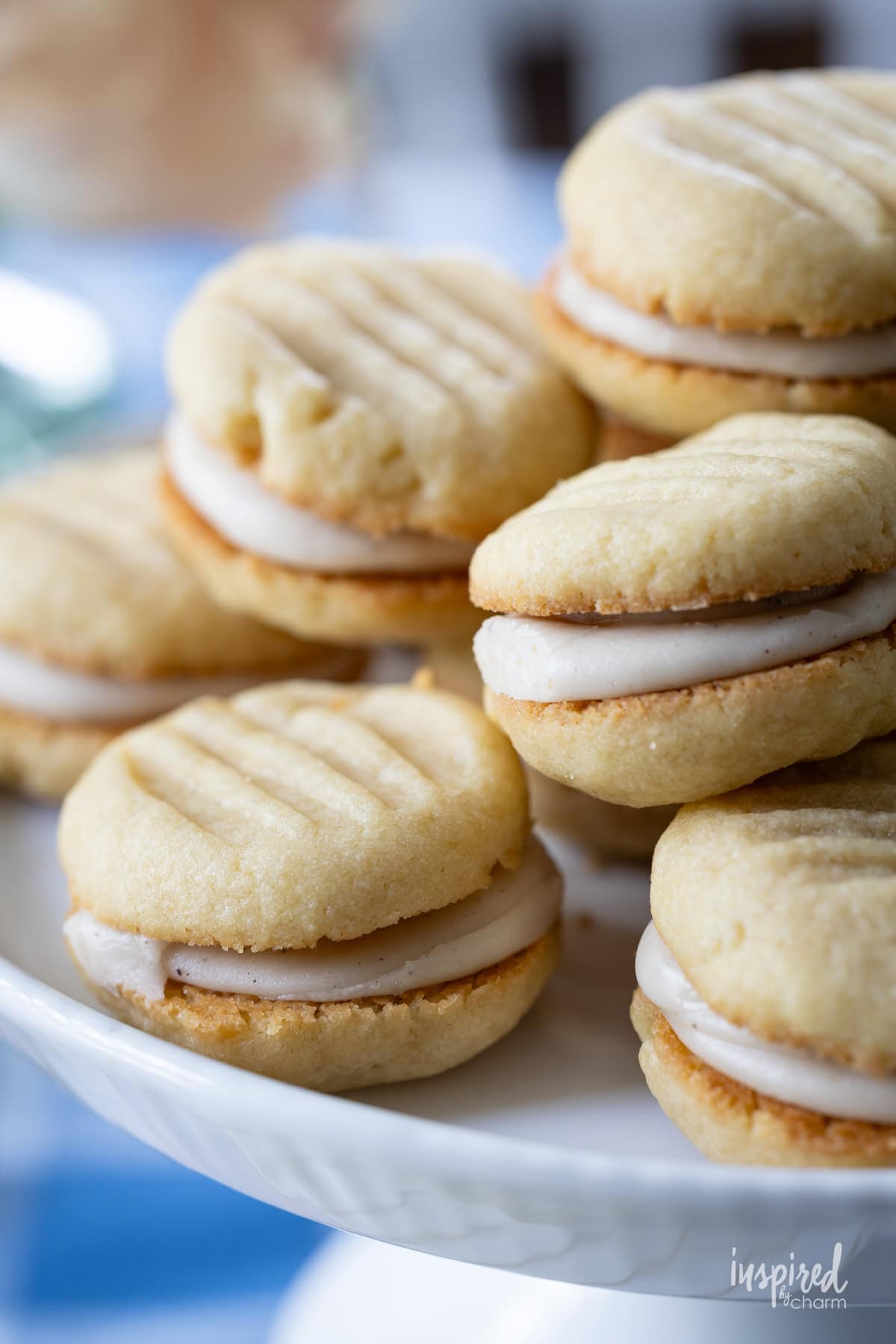 stack of Brown Sugar Cream Sandwich Cookies on a cake stand.