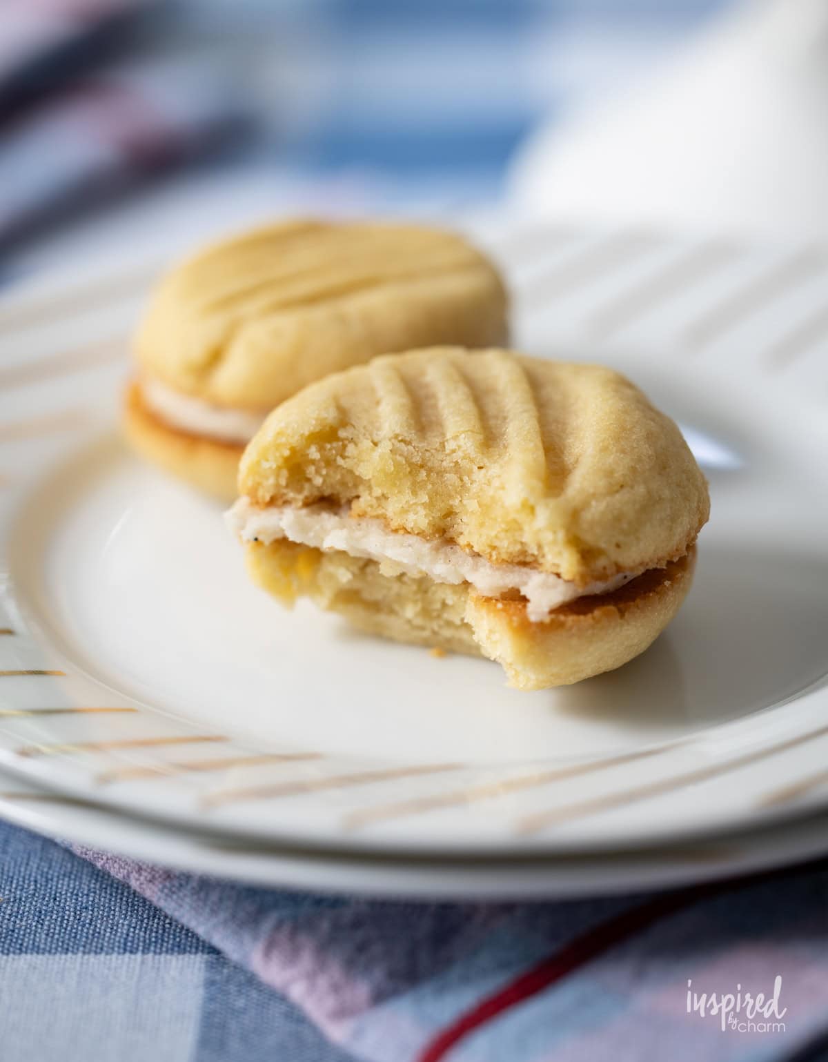 Brown Sugar Cream Sandwich Cookies with a bite taken from one.