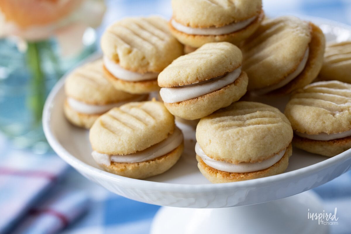 stack of brown sugar sandwich cookies on a cake stand.