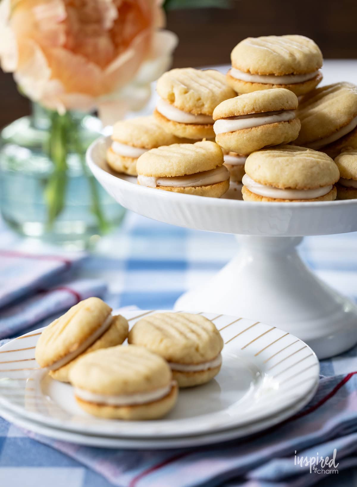 array of Brown Sugar Cream Sandwich Cookies on cake stand and plate.
