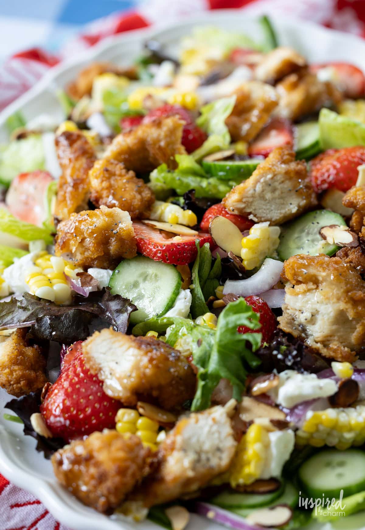 Crispy Chicken Strawberry Corn Salad filled with ingredients presented on a platter.