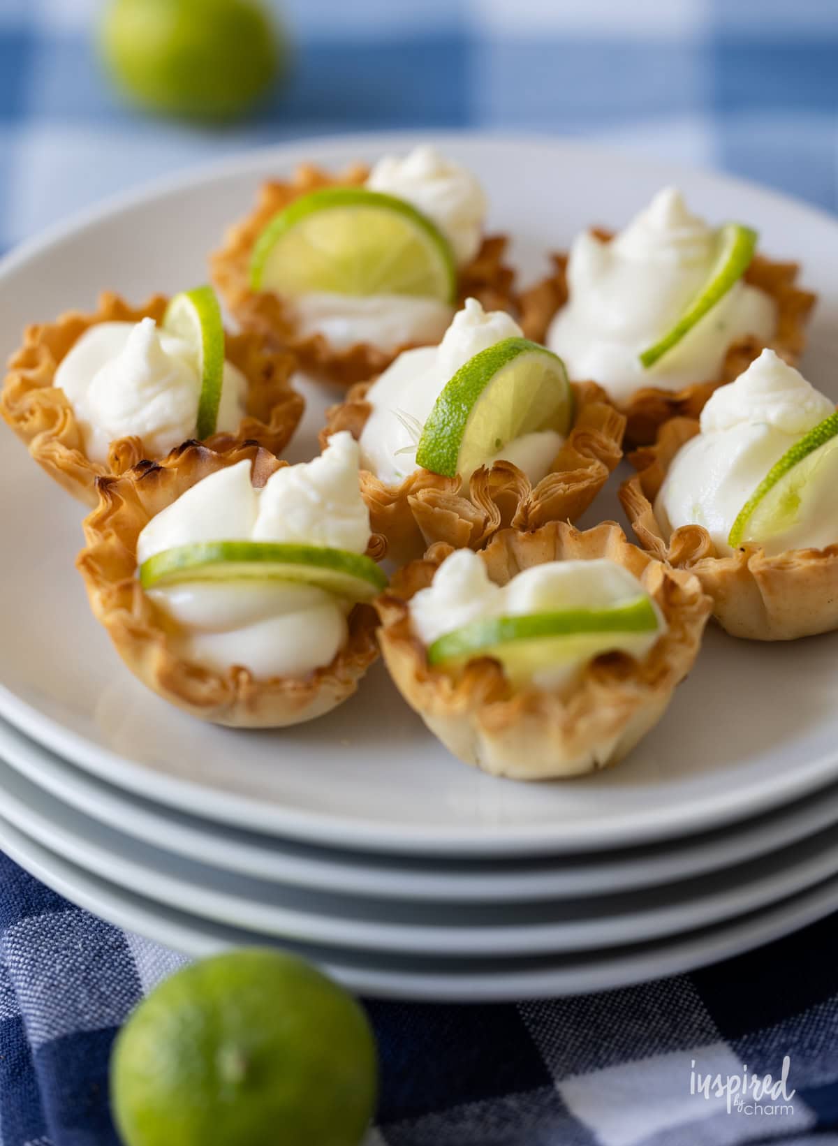 stack of plates filled with Key Lime Pie Tartlets.