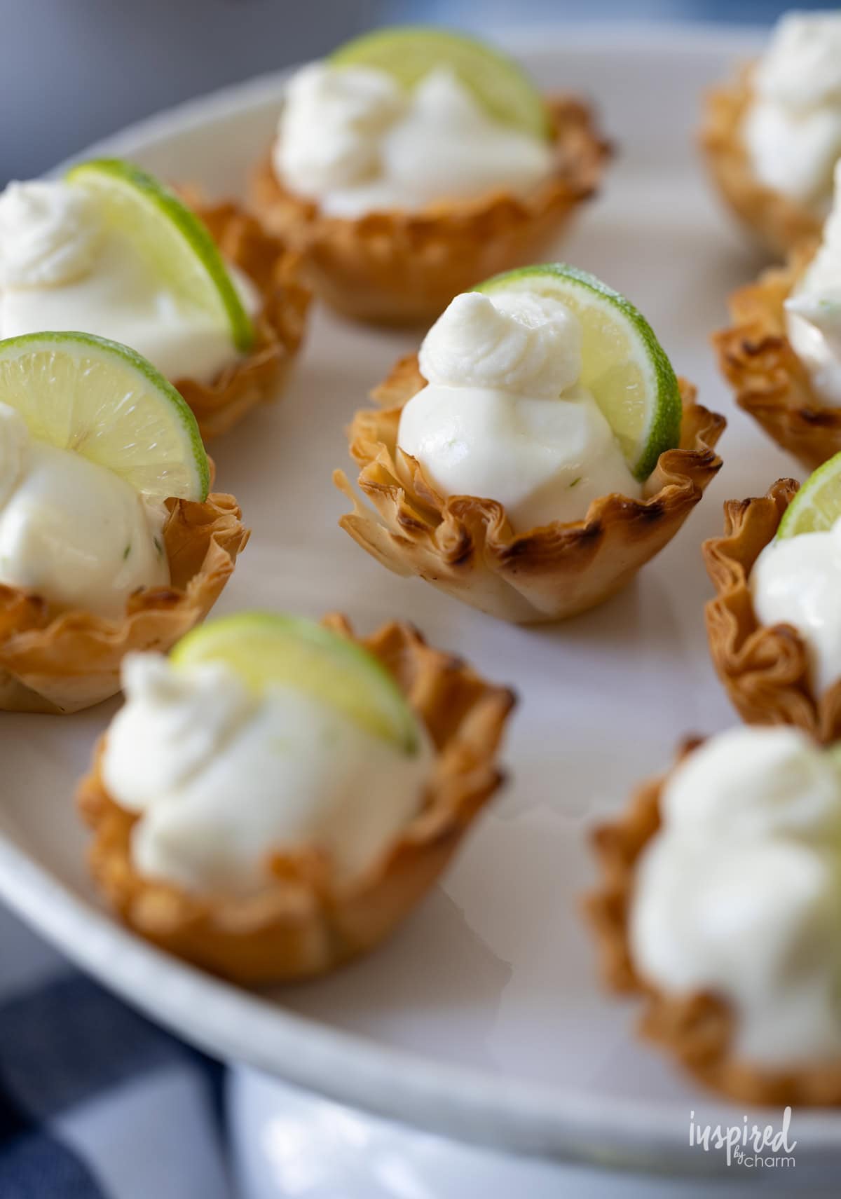 several Key Lime Pie Tartlets on a white stand.