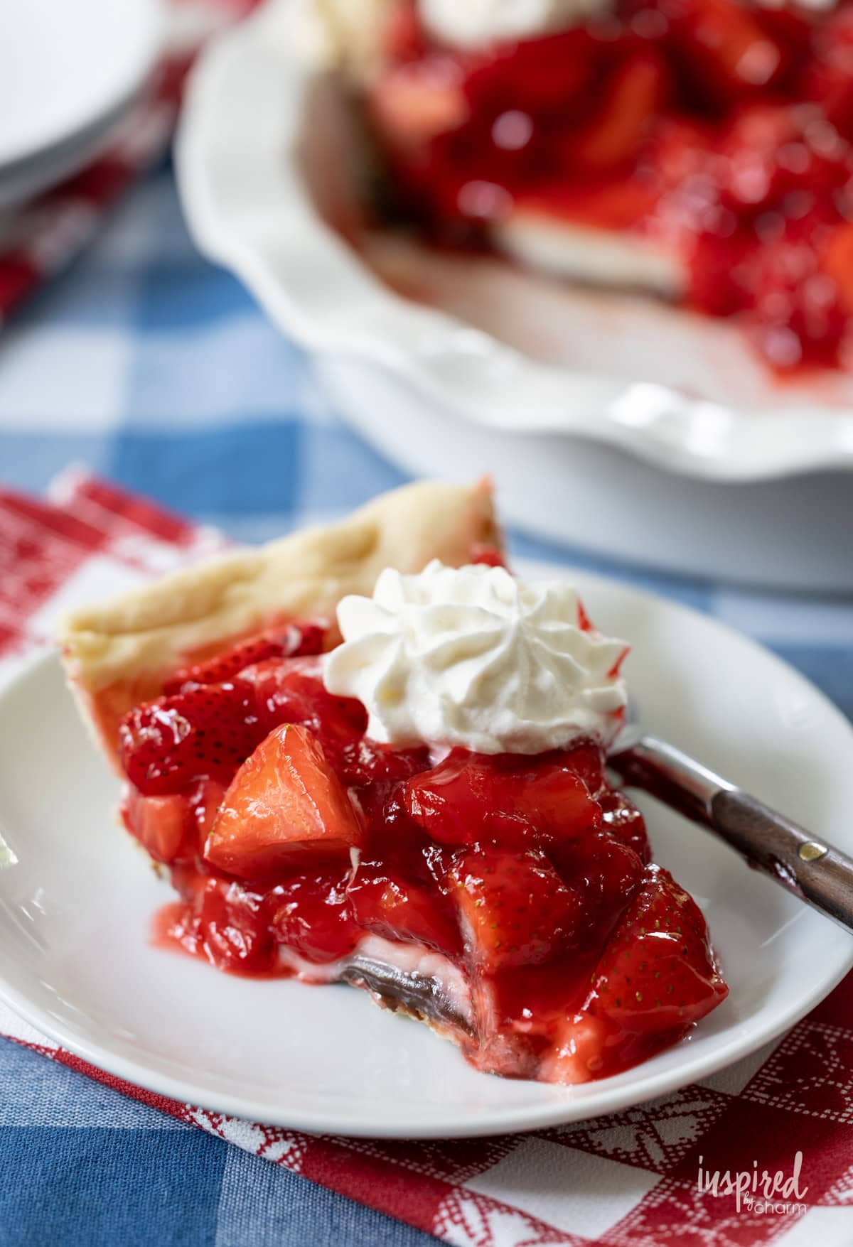 slice of Black Bottom Strawberry Pie served on a plate with a fork.