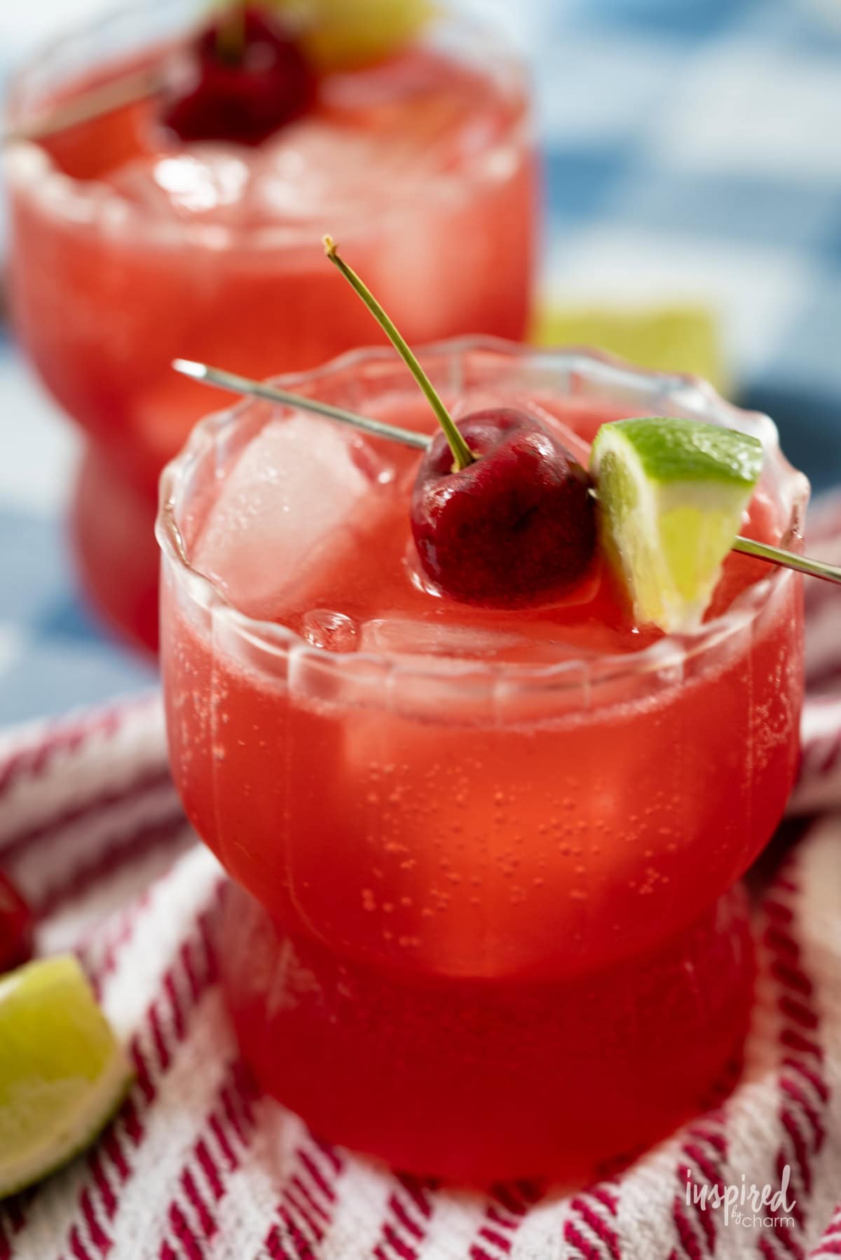clases of Cherry Lime Splash cocktail mocktail served with lime and cherry.