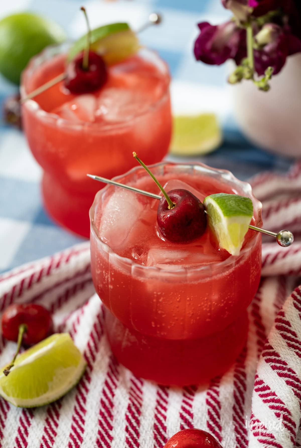 Two Cherry Lime Splash cocktail/mocktail drinks in glasses on a table.