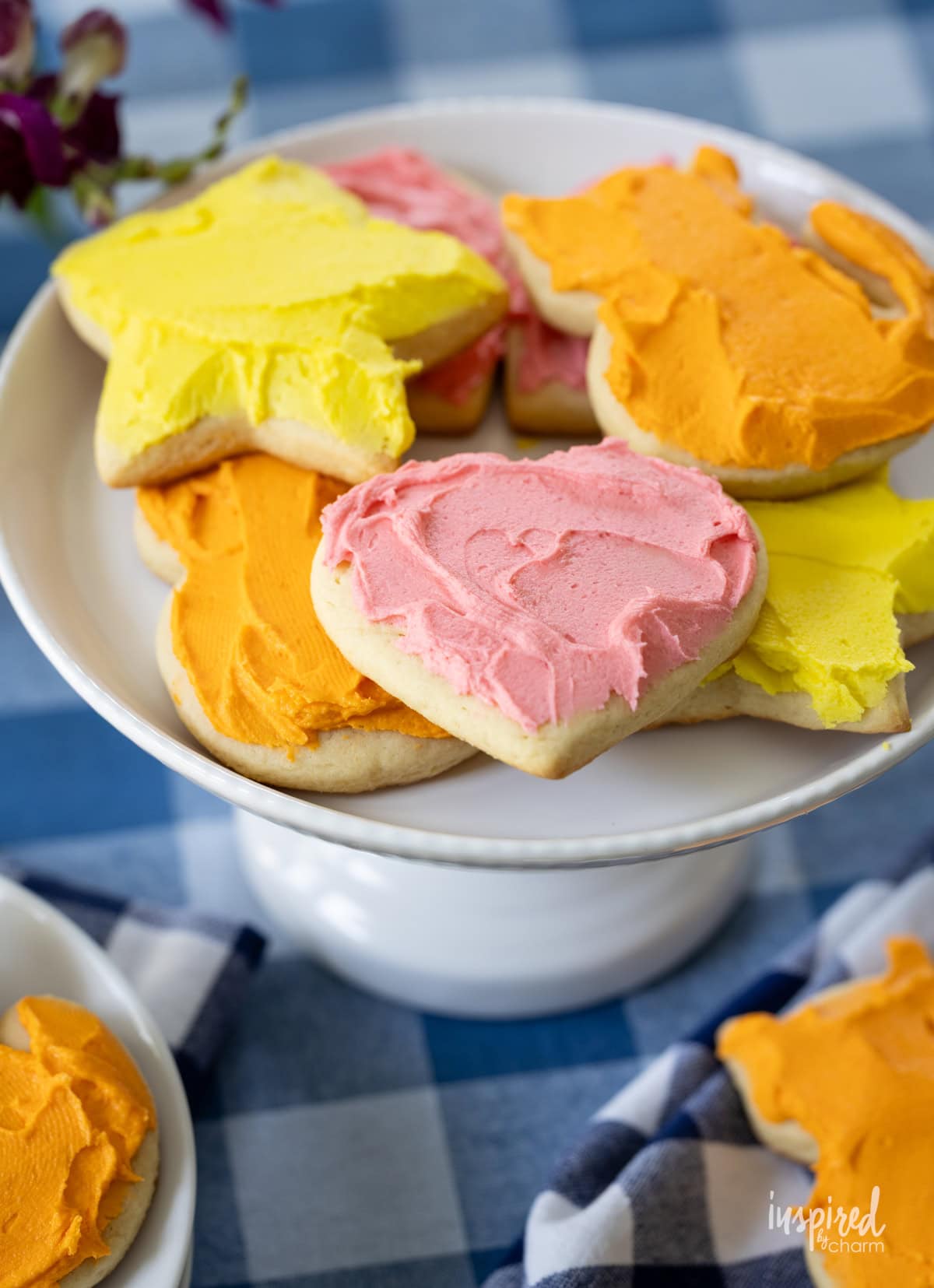 cake stand pilled with frosted sugar cookies.