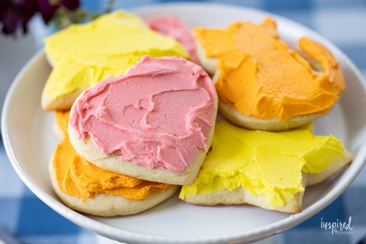 array of frosted sugar cookie on a small plate.