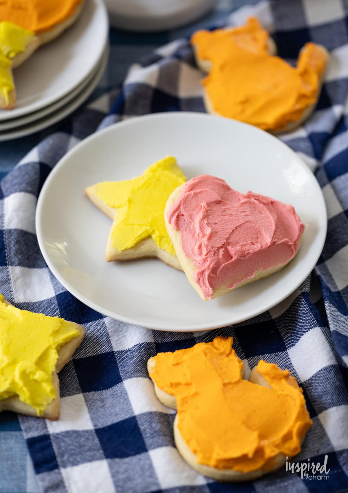 frosted sugar cookie on a table and on a small plate.