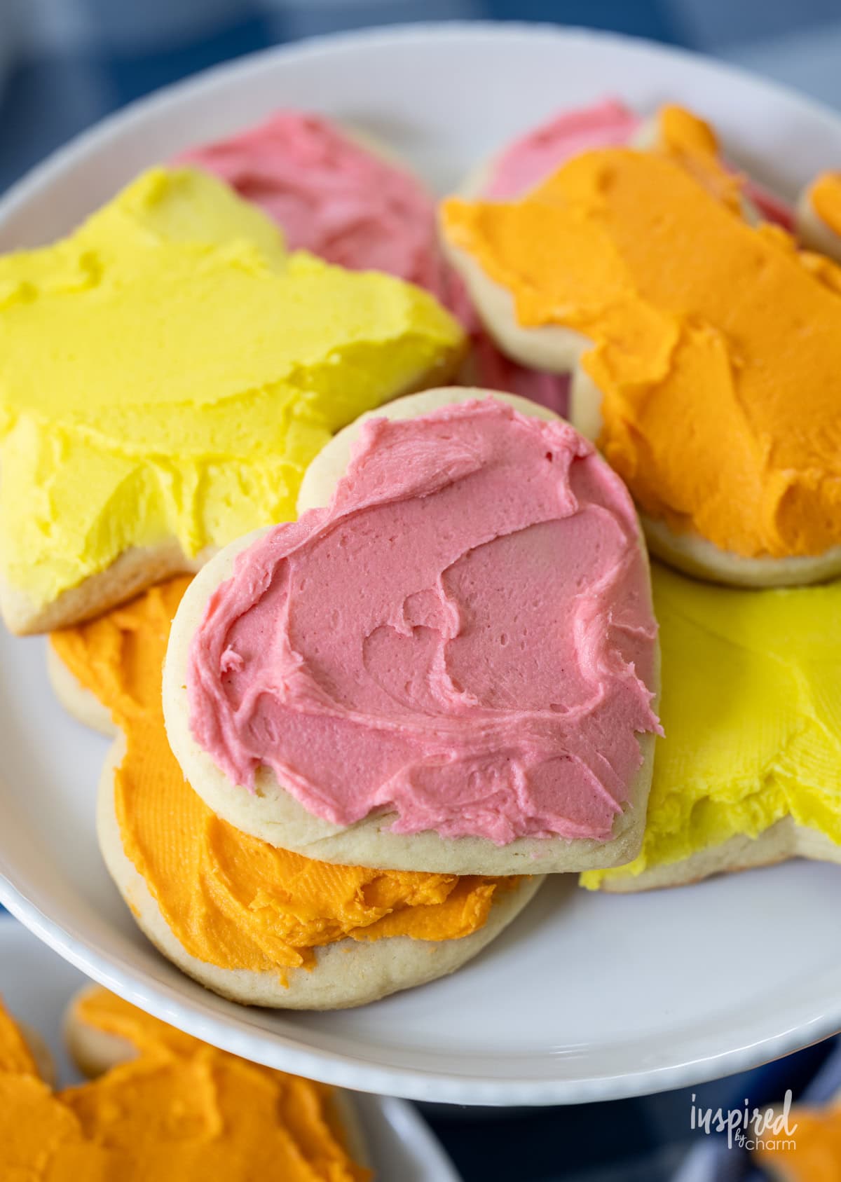 frosted sugar cookies on a plate.