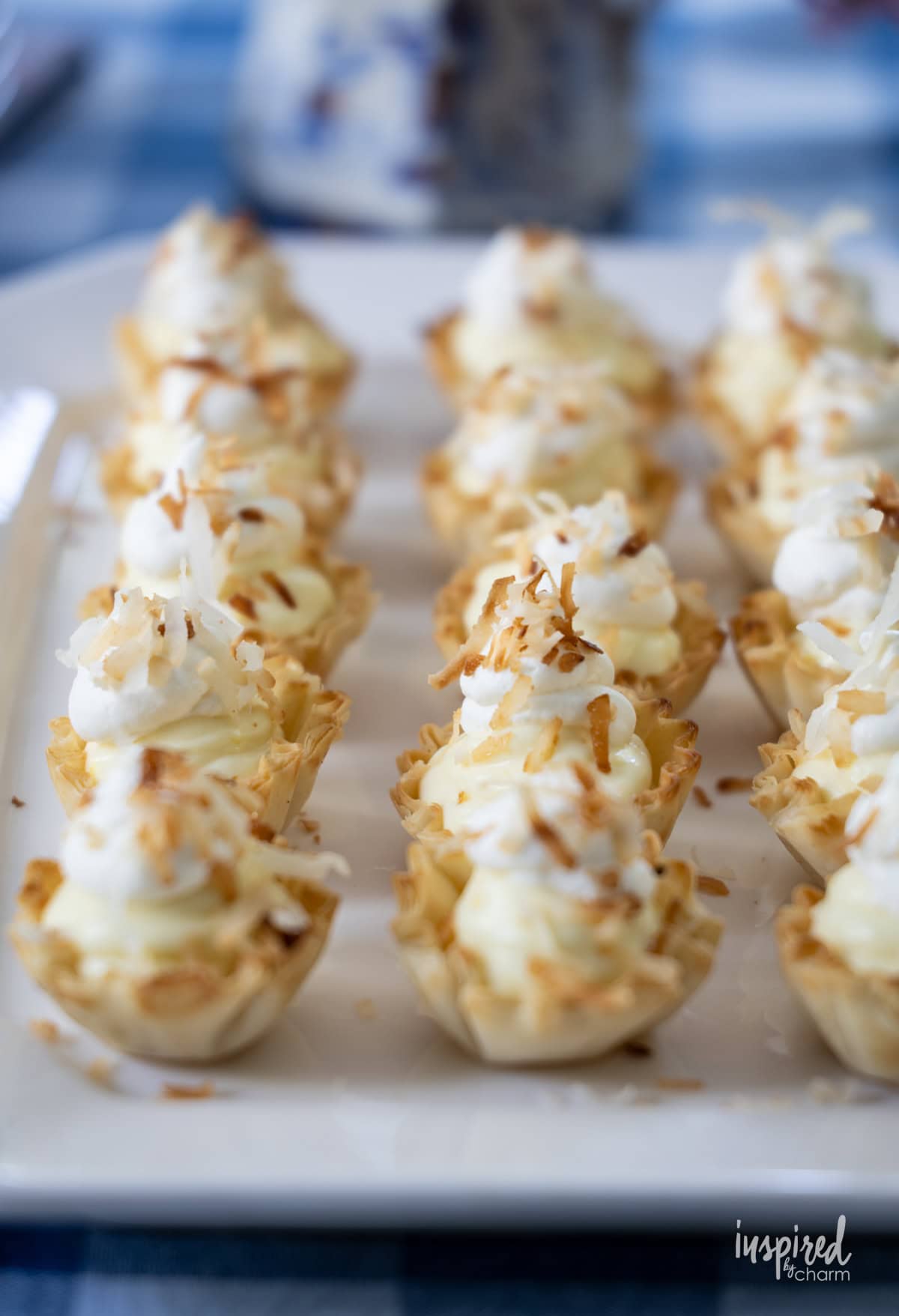 white plate filled withMini Coconut Cream Pie Tartlets. 