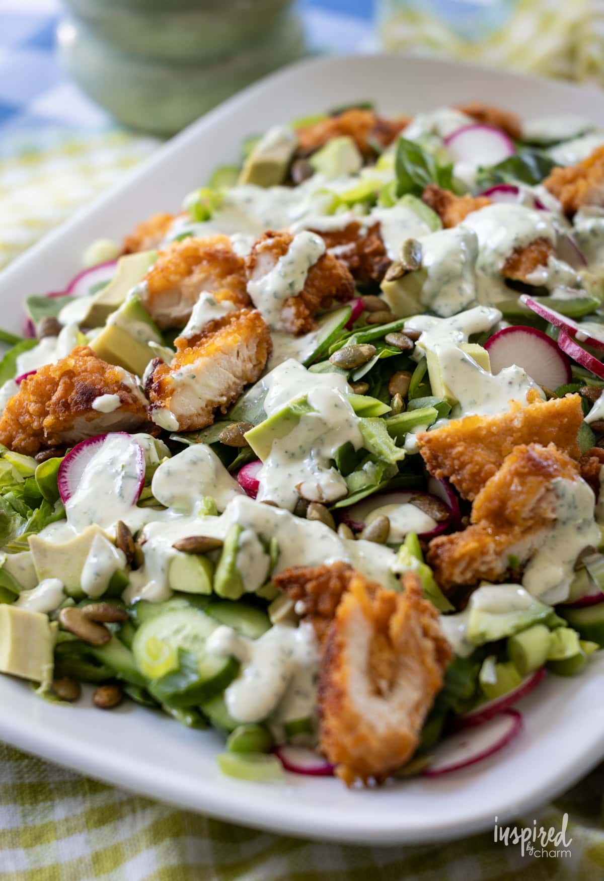 platter filled with green goddess salad with dressing.