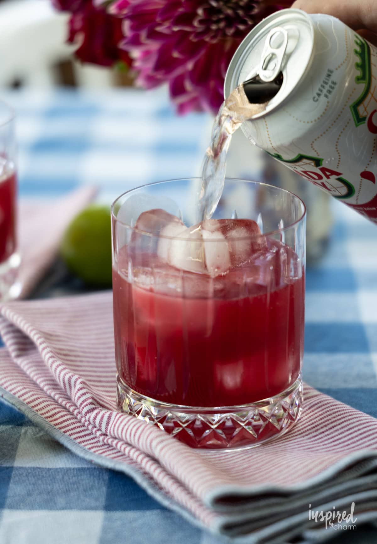 pouring cherry ginger ale into cocktail. 