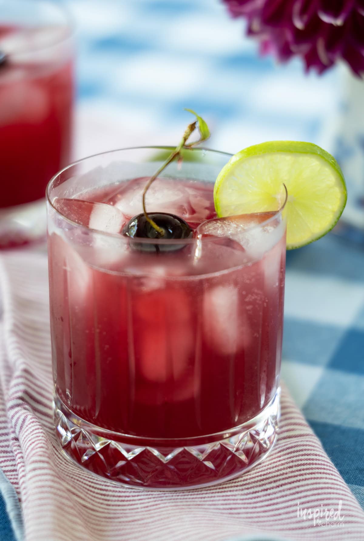 Cherry Pineapple Cooler drink in glass with cherry garnish. 