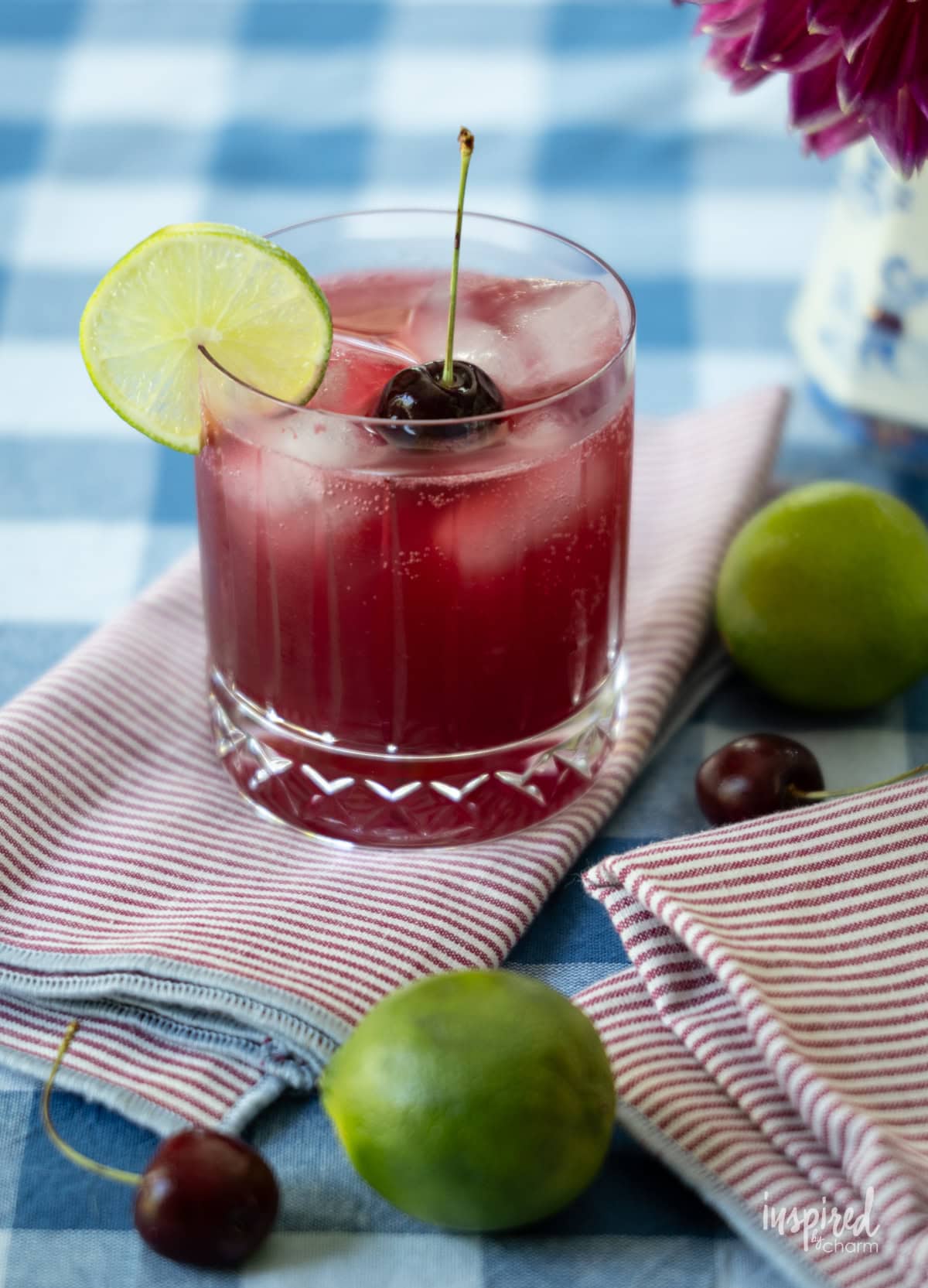 single glass of Cherry Pineapple Cooler on a napkin. 