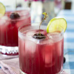 Cherry Pineapple Cooler cocktail / mocktail with cherry a and lime.