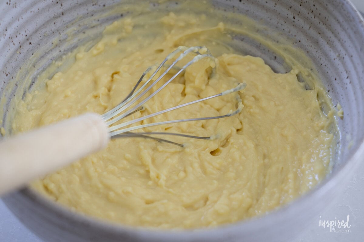 coconut pudding in a bowl with a whisk. 
