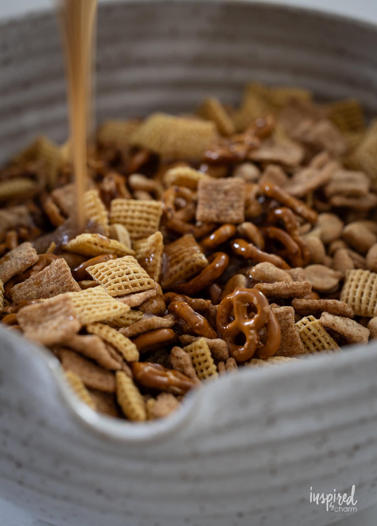 powering sugar over snack mix.