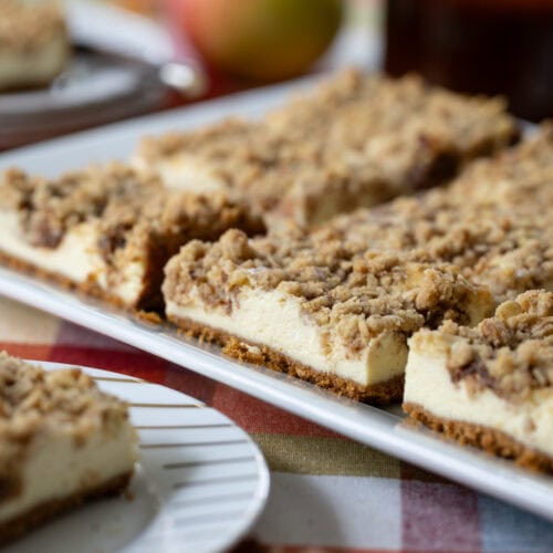 Apple Butter Cheesecake Bars on a table decorated for fall.