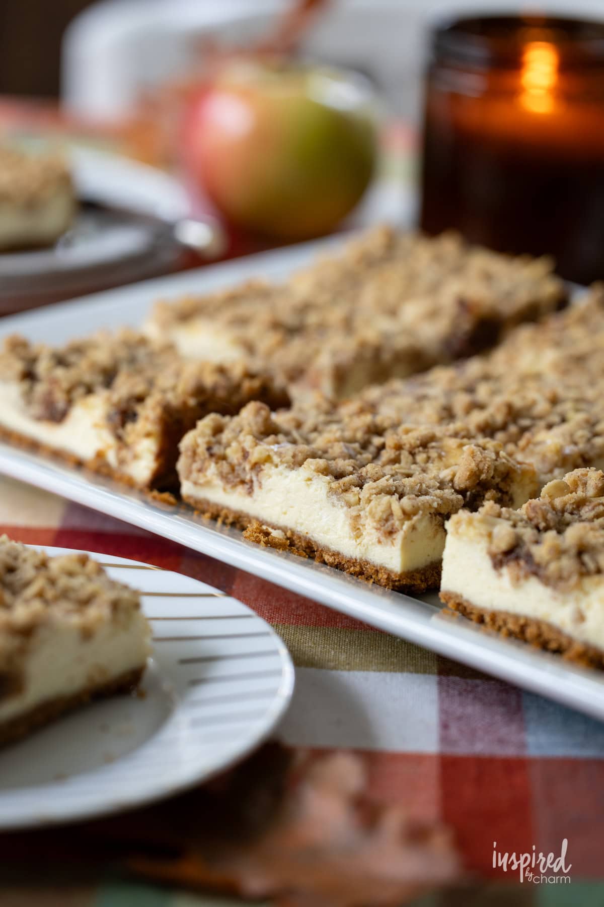 Apple Butter Cheesecake Bars on a table decorated for fall.