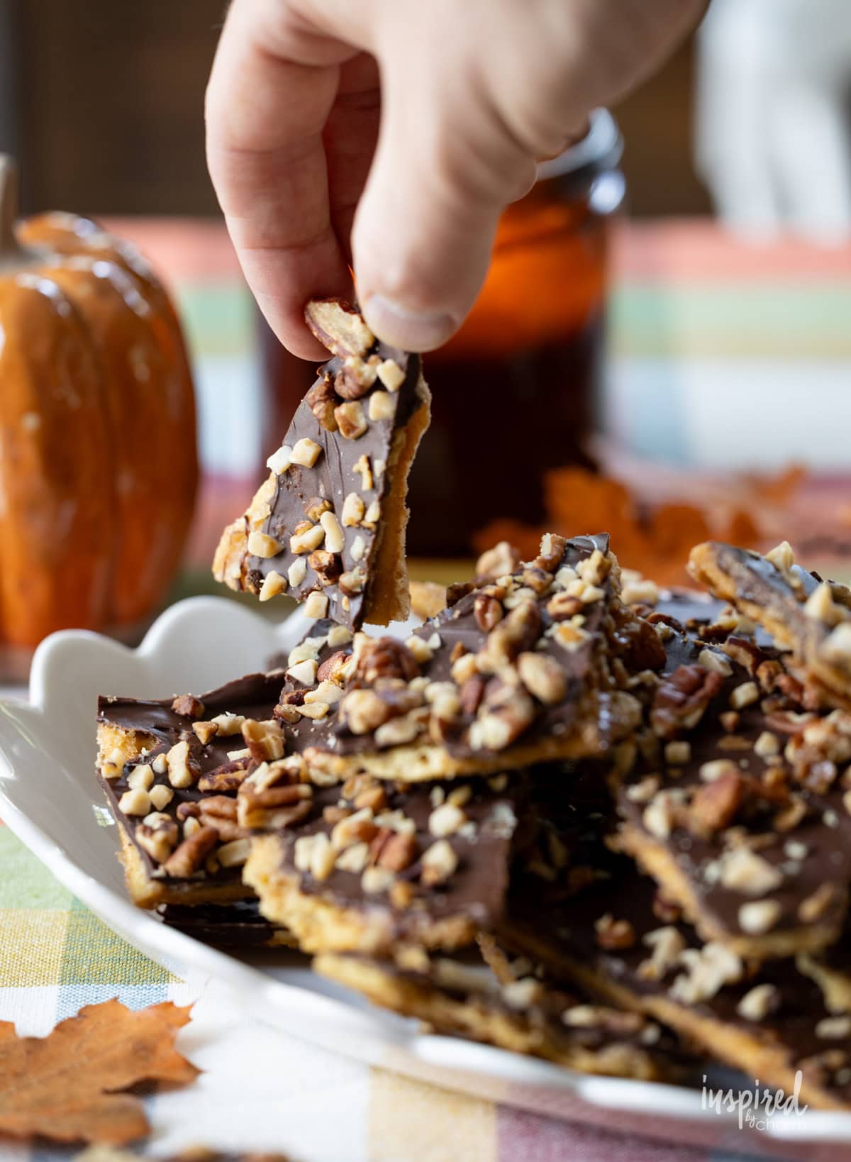 hand picking up a piece of Pumpkin Spice Cracker Toffee.