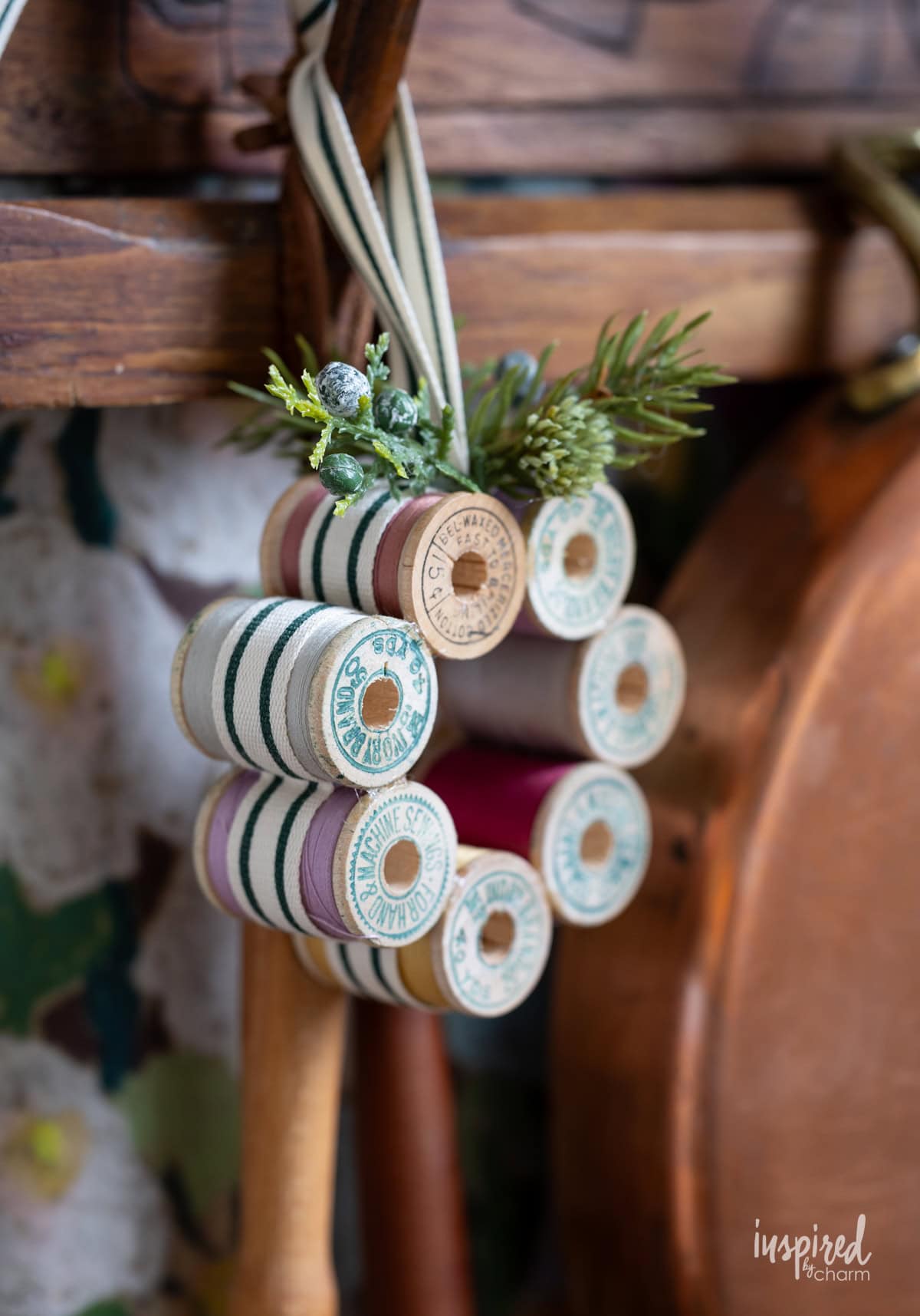 Vintage Thread Spool Mini Wreath hung on a rack.