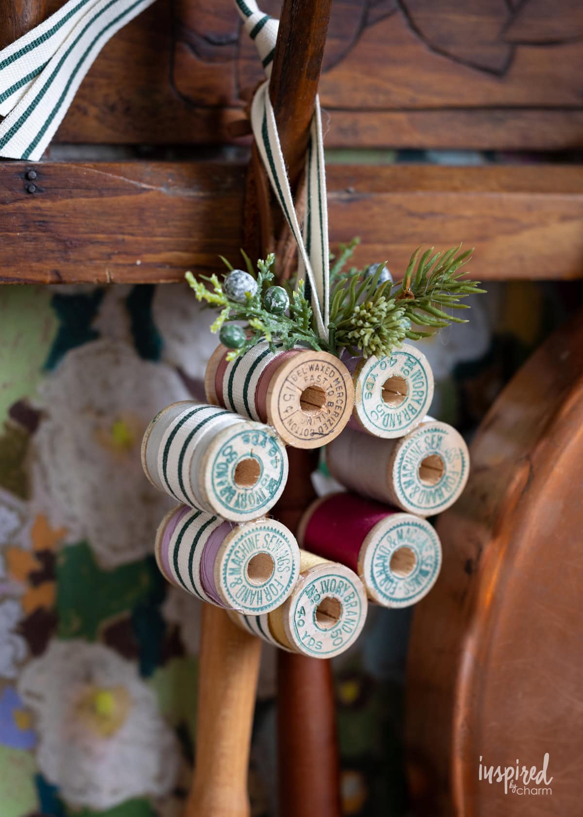 Vintage Thread Spool Mini Wreath hung on a peg in a kitchen.