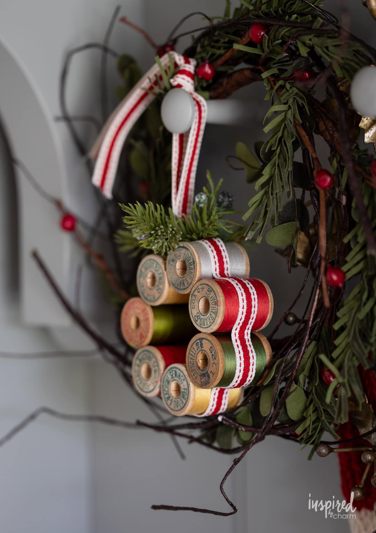 Vintage Thread Spool Mini Wreath hung with pine.