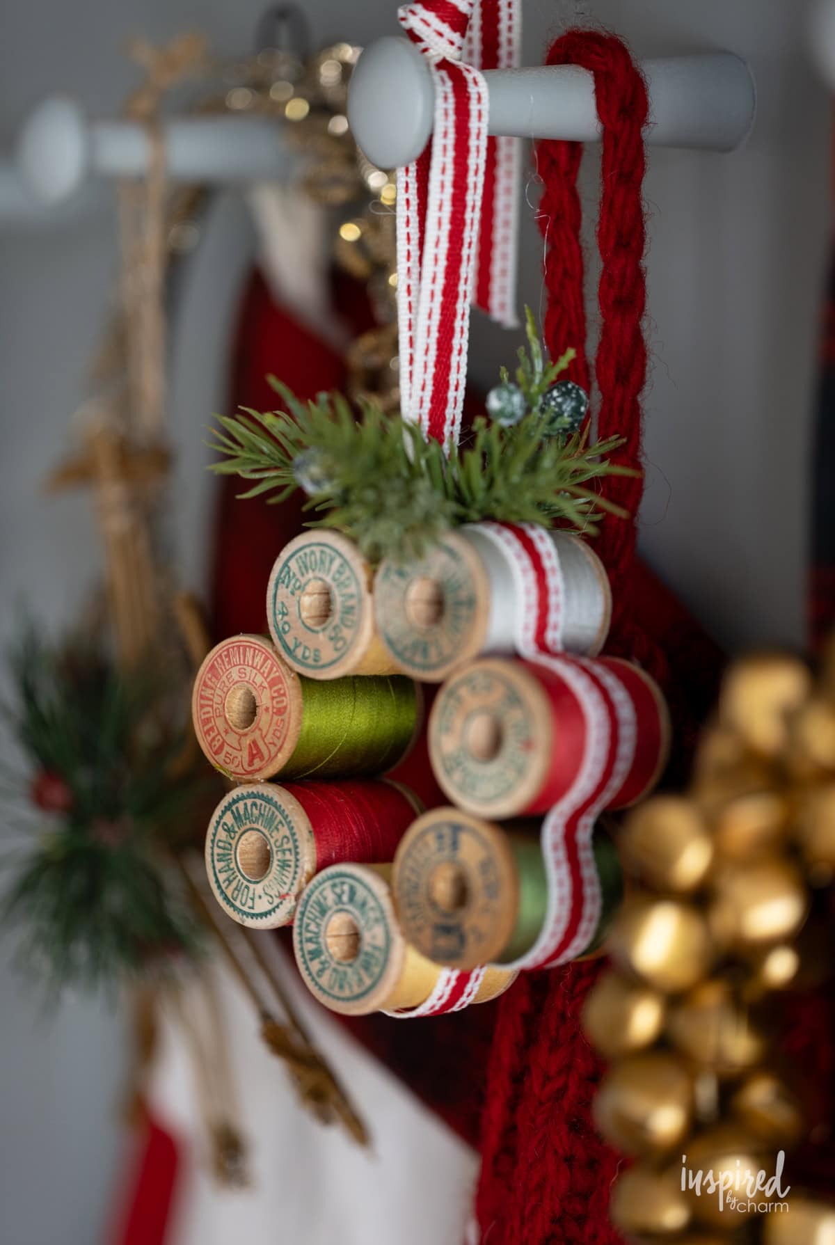 Vintage Thread Spool Mini Wreath hung with christmas decor.